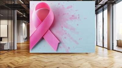 A vibrant pink ribbon symbolizes awareness and support for breast cancer initiatives, set against a soft blue background. Wall mural