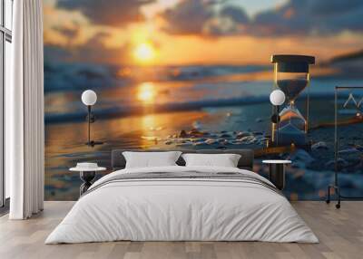 Hourglass on sand beach at sunset. Sand passing through glass bulbs Wall mural