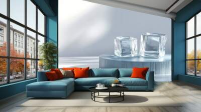 3D transparent ice cube on a glass podium alongside a blue wooden round podium on a white glossy surface serving as a backdrop for displaying luxury beauty cosmetic organic health and fashion produ Wall mural