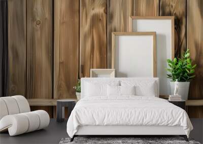 Photo frames and plant on shelf against wooden wall Wall mural