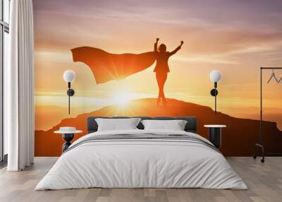 Silhouette back pose of businesswoman wearing cape and rise two fist up standing on cliff. concept of woman power, business success, leadership, target goal achieve, winner Wall mural