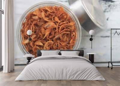 Fried onions in a jar on the table Wall mural