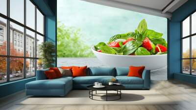 Fresh basil and ripe tomatoes create vibrant salad, promoting healthy eating and biodiversity. This colorful dish showcases beauty of organic ingredients in serene setting Wall mural