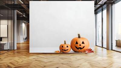 Halloween pumpkins with autumn leaves create festive atmosphere Wall mural