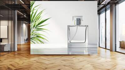 Minimalist glass perfume bottle on marble surface with greenery. sleek design and clear glass create elegant aesthetic, perfect for showcasing fragrance Wall mural