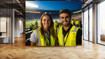 Cheerful Young Stewards in Stadium Wall mural