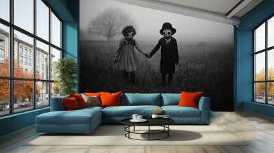 black and white horror photo of two creepy kids wearing vintage halloween costumes and masks in a misty field at night. Wall mural