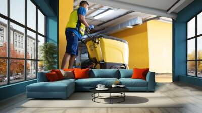 cleaning professional working in garage cleaning with sweeping machine Wall mural