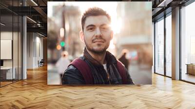 Close up of man with beard smiling at sunset in Barcelona city Wall mural