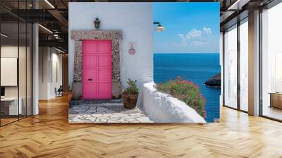 White house on the coast with pink door, beautiful spring scenery Wall mural