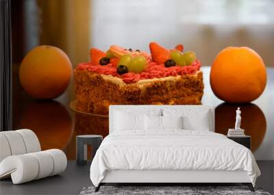 valentine's day cake with two oranges on a brown glossy table top Wall mural