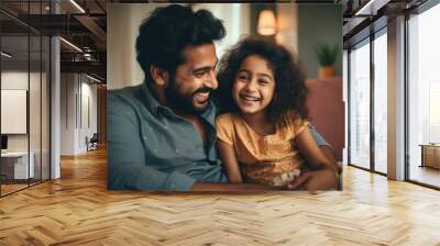 Loving young father of Indian ethnicity and little daughter having a fun time at home Wall mural