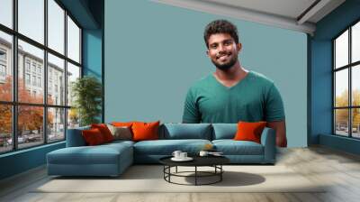 Portrait of a smiling young man of Indian origin Wall mural