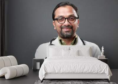 Smiling portrait of a doctor of Indian ethnicity Wall mural