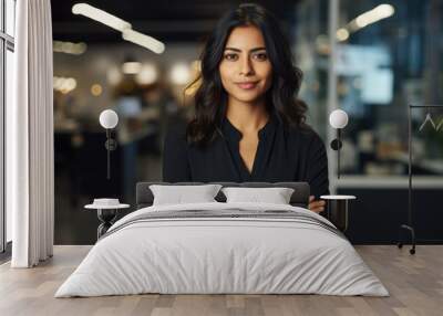 Smiling young confident woman of Indian ethnicity standing in a corporate office Wall mural