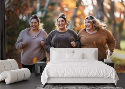 Three oversized female friends jogging in the park together in the morning Wall mural