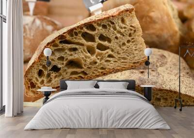 Fresh bread in the bakery. A slice of brown bread at the grocery store. Wall mural