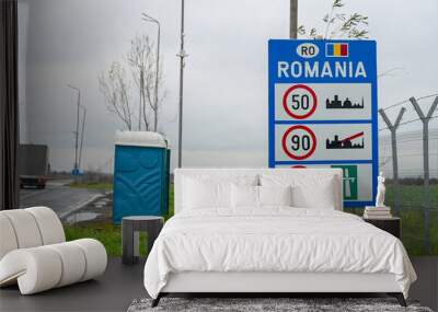 Sign at the entrance to Romania. The border between the Romania and Serbia. Highway. Inscription: Romania.   Wall mural