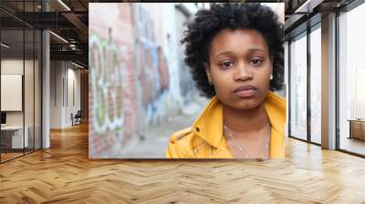 Close up portrait of an attractive young black woman with afro hair with copy space on the right  Wall mural