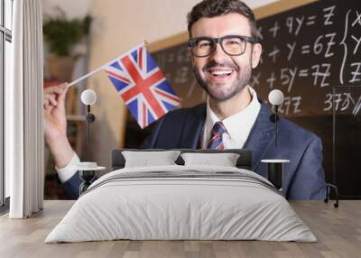 Elegant teacher holding the British flag Wall mural