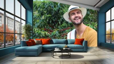 Handsome farmer in coffee plantation Wall mural