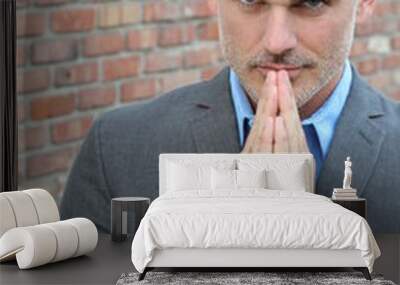 Handsome mature man with beard praying Wall mural