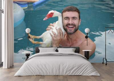 Man and his cute duck pet on vacations together Wall mural