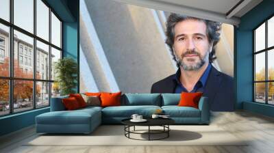 Portrait of a handsome man with grey hair looking to the camera Wall mural