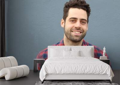 Portrait of smiling young bearded man with copy space  Wall mural