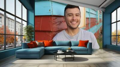 Sexy man smiling in blue and red wooden background Wall mural