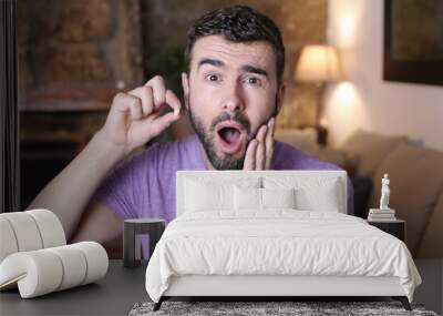 Young man losing a tooth Wall mural