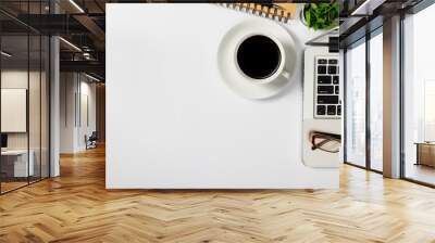 White office desk table with blank screen laptop computer,notebook,mouse,cup of coffee and other office.Top view with copy space Wall mural