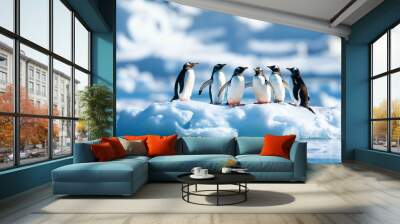 A delightful gathering of gentoo penguins on a glistening ice floe, surrounded by stunning blue waters and majestic icebergs, showcasing their playful social behavior in the Arctic. Wall mural