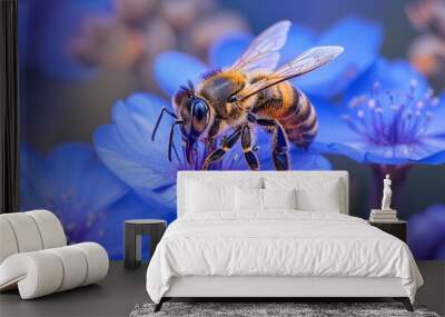 A highly detailed macro photograph captures a bee collecting nectar from vivid blue flowers, showing intricate textures of the bee's body and the delicate petals, set against a blurred background. Wall mural