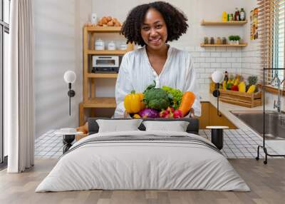  African American housewife is showing variety of organic vegetables to prepare simple and easy cajun southern style salad meal for vegan and vegetarian soul food concept Wall mural