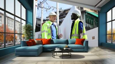 African American and Caucasian engineer are discussing about solar energy at site for industrial and construction concept Wall mural