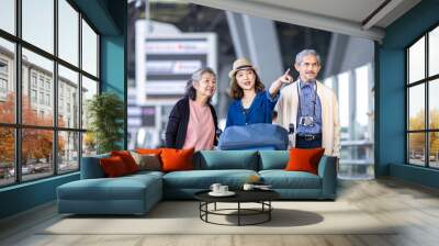 Group of Asian family tourist passenger with senior is leaving airport terminal for transportation during their vacation travel and long weekend holiday concept Wall mural