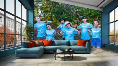 Team of young and diversity volunteer worker group enjoy charitable social work outdoor in mangrove planting project wearing blue t-shirt Wall mural