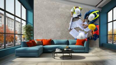 Top view of engineer, architect, contractor and foreman meeting at the construction building site with floor plan for real estate development project industry and housing timeline concept Wall mural