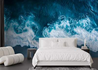 Aerial drone view or top view perspective photography of a beautiful transparent clear sea or ocean waves and foam splashing on the dark navvy blue or gray sand beach Wall mural