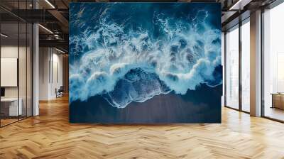 Aerial drone view or top view perspective photography of a beautiful transparent clear sea or ocean waves and foam splashing on the dark navvy blue or gray sand beach Wall mural