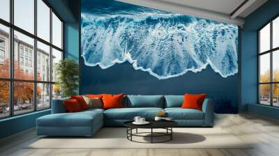 Aerial drone view or top view perspective photography of a beautiful transparent clear sea or ocean waves and foam splashing on the dark navvy blue or gray sand beach Wall mural