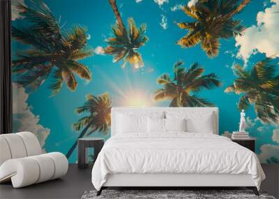 Low angle view, palm trees against the blue sky as a backdrop. Wall mural