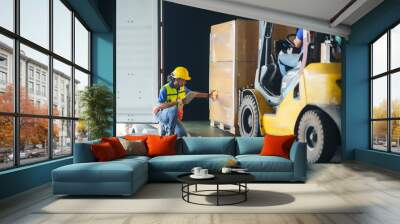 asian forklift driver loading a shipping cargo container with a full pallet with boxes in logistics  Wall mural