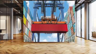 Shore crane lifts container during cargo operation in port Wall mural