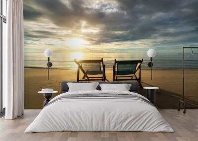 Two deckchairs on the beach at sunset with a tropical sea background. Travel and Vacation in Summer at sea. Wall mural