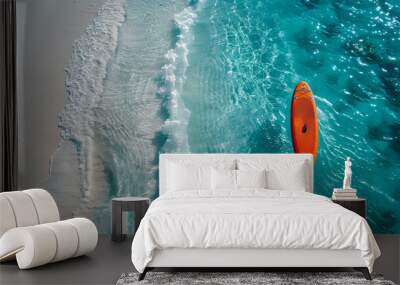 An orange and blue paddleboard on the beach, a bird's eye view, high definition photography, clean white sand, clear turquoise sea water, waves lapping at shore edge, and a sense of calmness. Wall mural