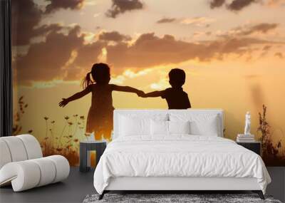 Happy Children's silhouettes at sunset, Happy family, Children jumping at sunset, Child care and mental protection, joyful and healthy children Wall mural