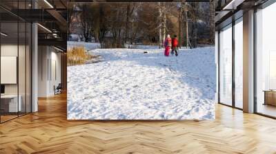 two little school girls are walking in snow Wall mural