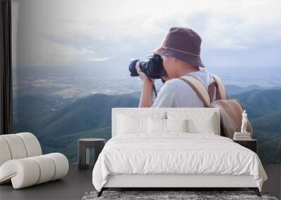 Photographer using Camera DSLR, Digital Single Lens Reflex take a photo Mountain and blue sky. Traveling Concept. Hiker concept. Wall mural